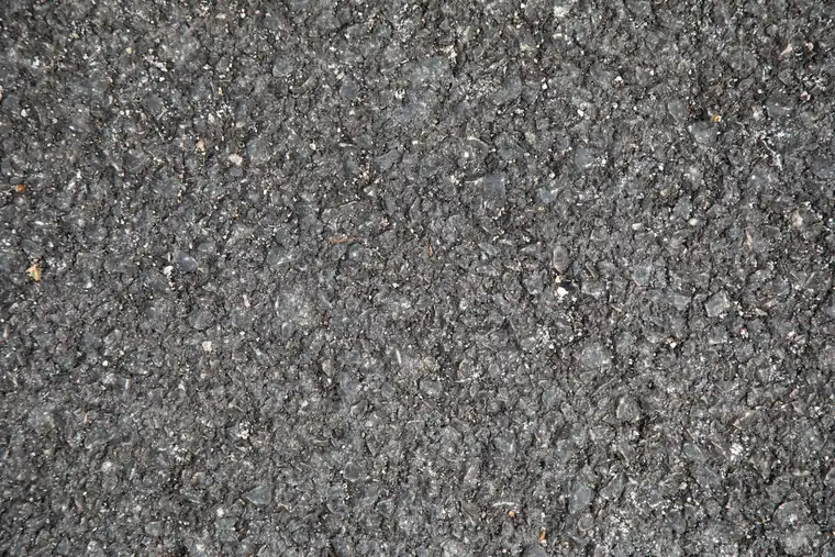 Close-up of an aged mineral-surfaced bituminous covering of the kind stripped from Weston garage roofs