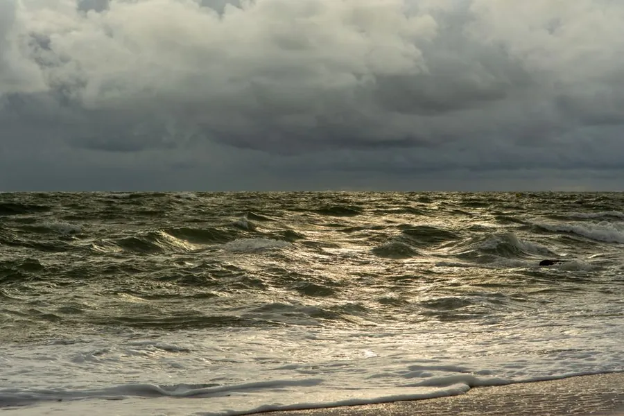 Wind-driven swell and a heavy grey sky over the Bristol Channel coast near Weston-super-Mare