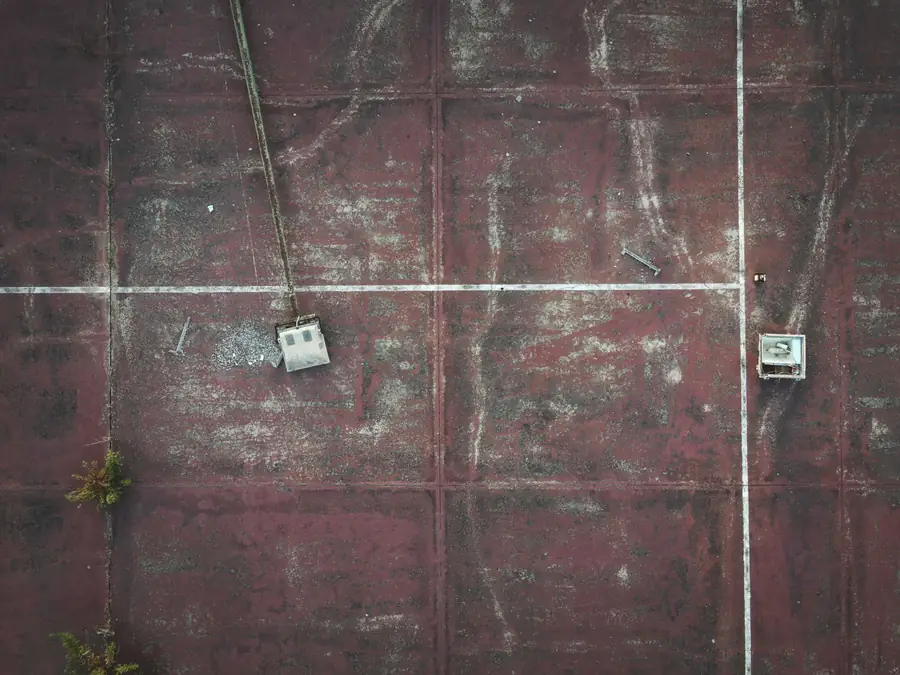 An aged bitumen flat roof surface photographed from above, weathered and approaching the end of its service life