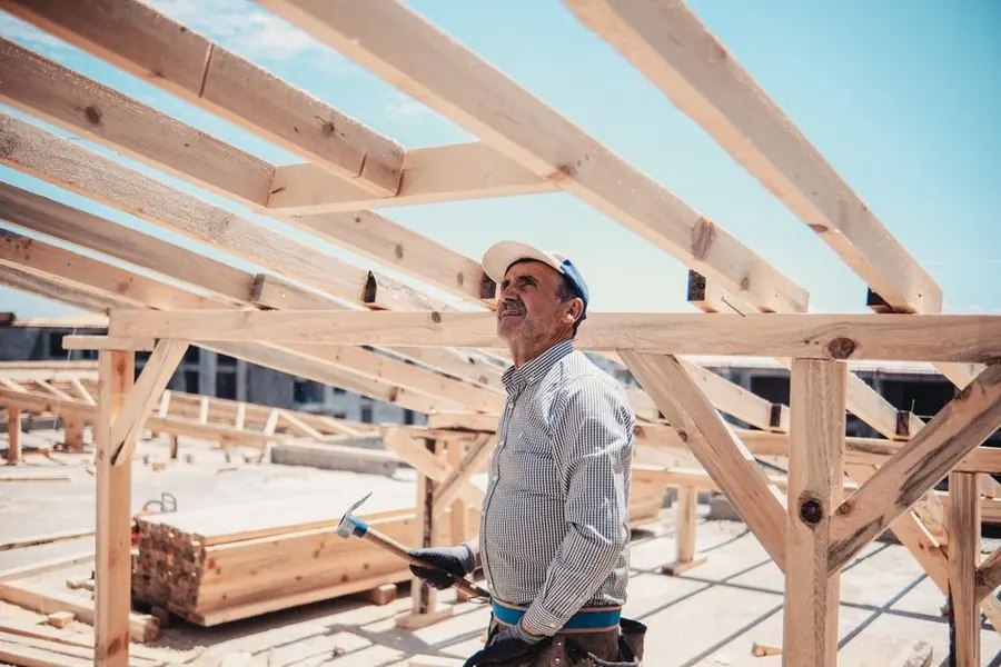 A roofer looking over a roof structure before deciding on a build-up, near Weston-super-Mare
