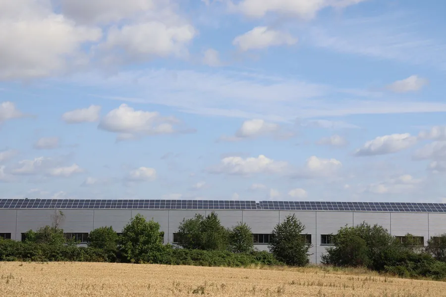 A commercial unit with a rooftop solar array, the kind of roof whose remaining life should be checked before panels go on near Weston-super-Mare