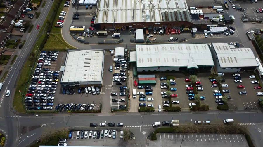 Aerial view of a UK industrial estate with large flat-roofed commercial units, similar to the estates inland from Weston-super-Mare