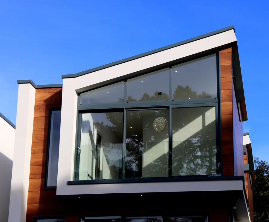 A contemporary house with a low-pitched roof, timber cladding and a glass-fronted balcony over the ground floor, the kind of design that needs planning approval in North Somerset