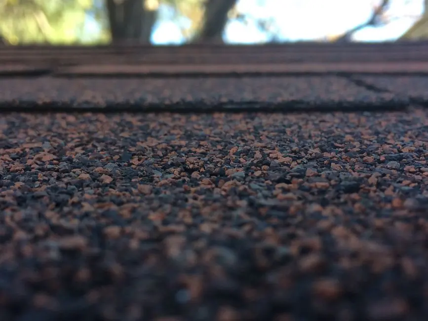 Close-up of a weathered roof surface worn thin by years of sun, rain and frost