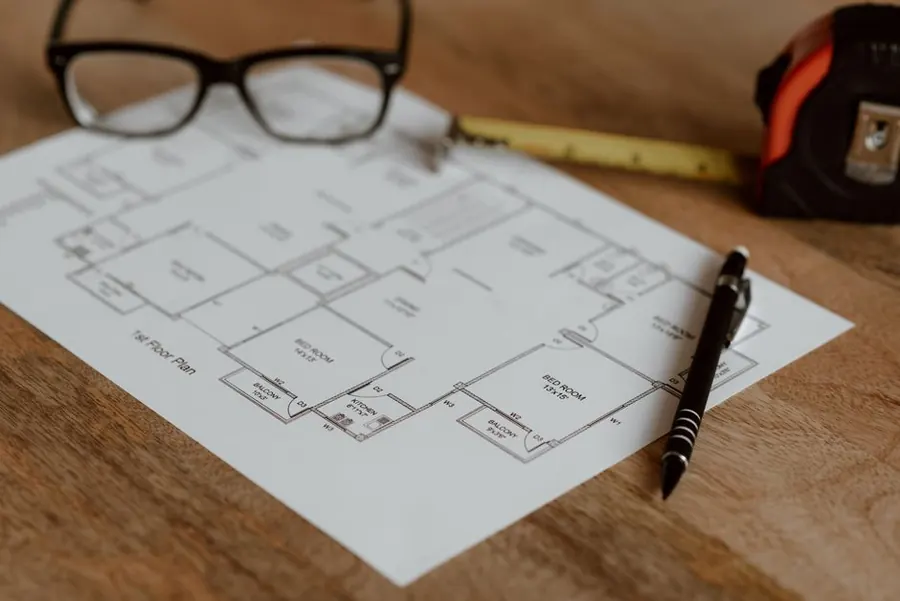 Plans and drawings for a flat roof upgrade being checked against building regulations in North Somerset