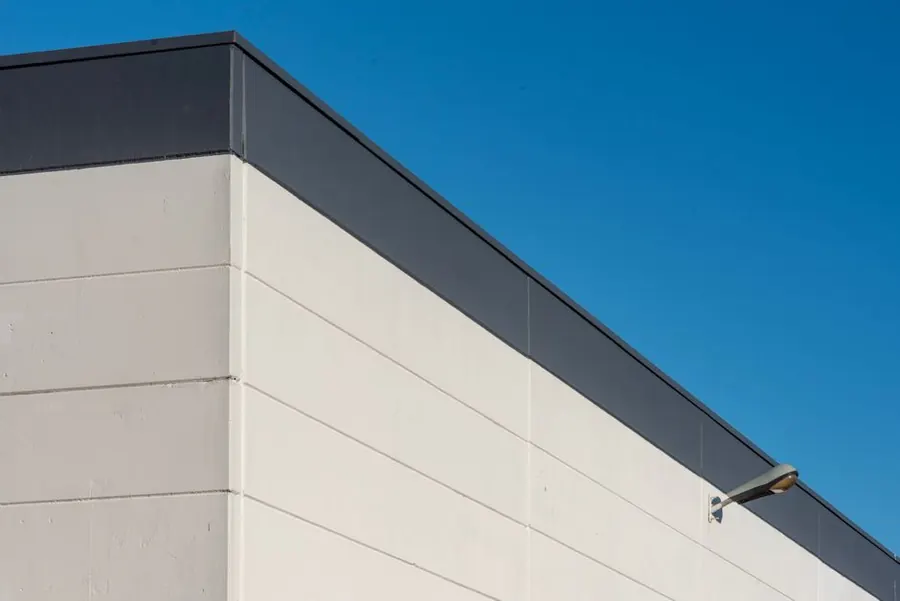 The clean edge and trim of a sound flat roof, the sort of covering where a liquid coating is a sensible way to add years