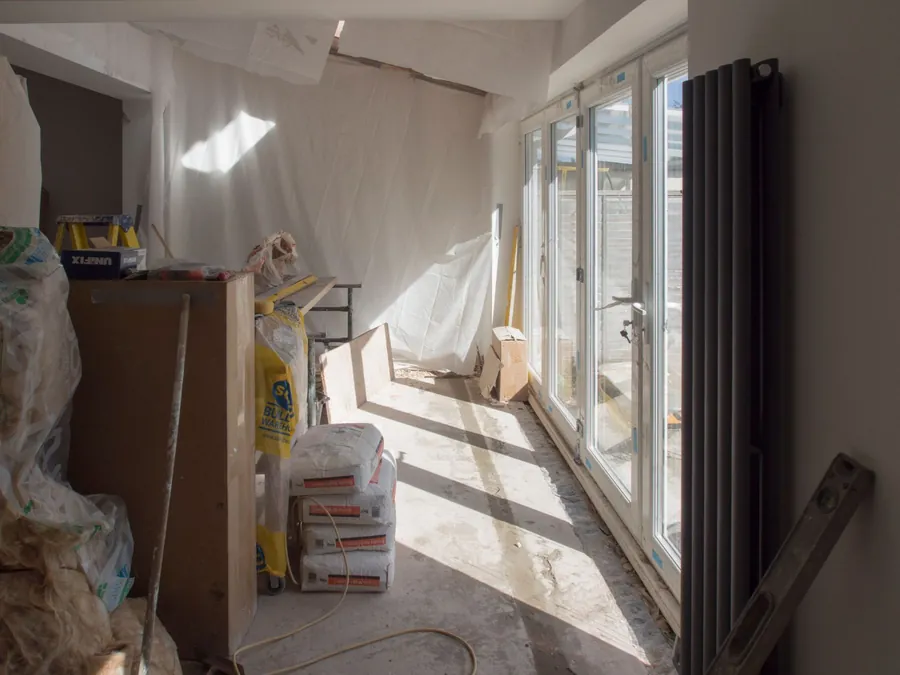 Inside a single-storey extension part-way through the build, with the doors in and materials stacked, the size of flat roof quoted in days around Weston-super-Mare