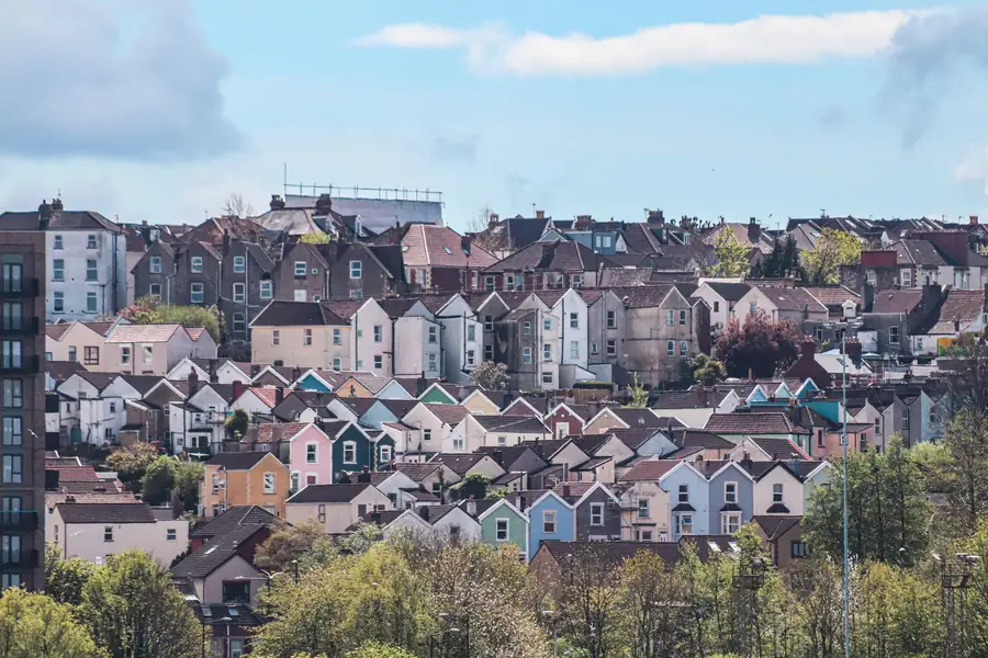 Terraced and semi-detached houses stacked up a hillside in the Bristol and North Somerset area, many with loft conversions