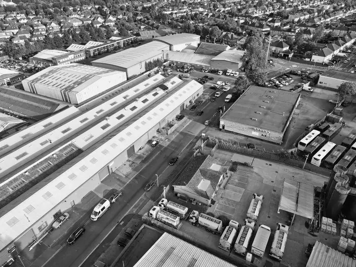 Industrial units with flat and low-pitched roofs set right up against a residential street, the mix of workshops and housing found in Highbridge