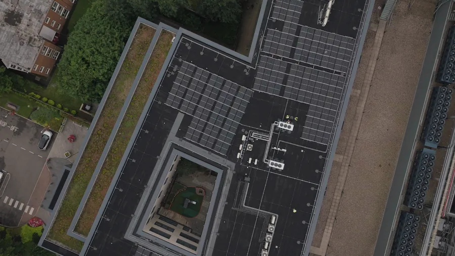 An aerial view of a large commercial flat roof with rooftop plant, pipework and solar panels needing careful waterproofing detail