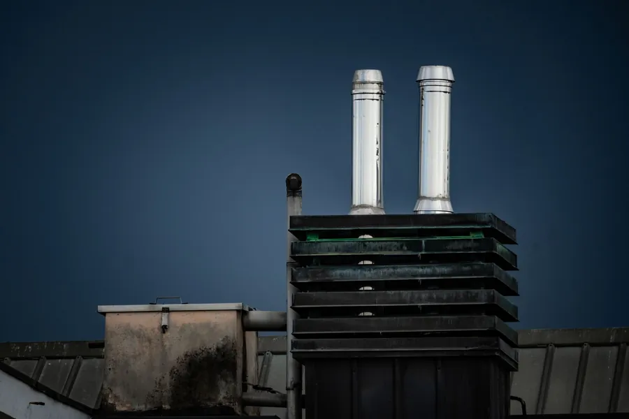Flues, extract plant and upstands rising from a commercial flat roof, the details where waterproofing systems succeed or fail