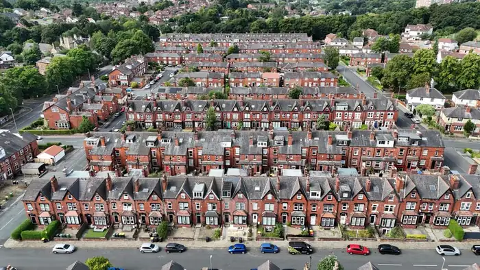 Rows of British terraced houses with rear additions where flat roof build-up height is constrained, typical of streets around Weston-super-Mare
