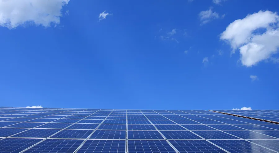 Tilted solar panels seen against the sky, the shape that catches wind uplift on an exposed coastal roof near Weston-super-Mare