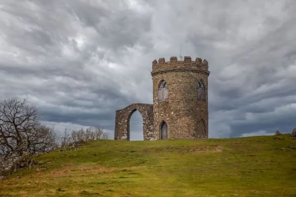 A castellated stone folly on a grassy hilltop, the kind of Victorian romance Banwell Castle brings to its hillside