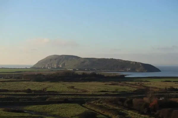 A long grassy headland reaching into the sea, Brean Down stretching out near Burnham-on-Sea