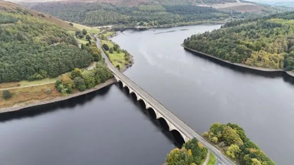 A reservoir ringed by green hills seen from above, the kind of waterside circuit Cheddar's reservoir gives walkers