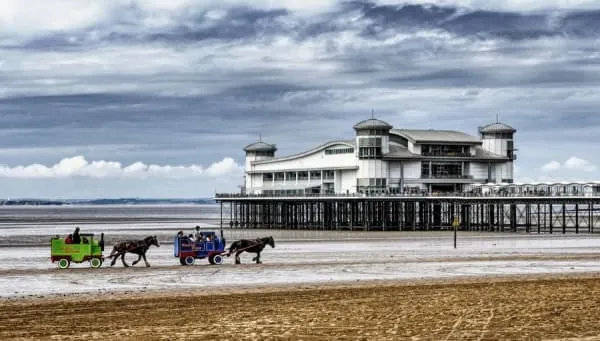Donkey carts on the sand beneath Weston's Grand Pier, the seafront scene ten minutes from Locking