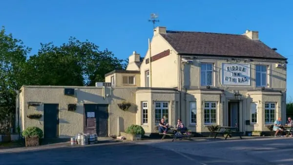 A traditional English village pub exterior, the kind of welcome The Old Inn offers on Hutton's Main Road
