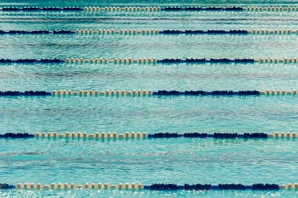 Lane ropes across the blue water of an outdoor pool, the open-air swimming Portishead's lido is known for