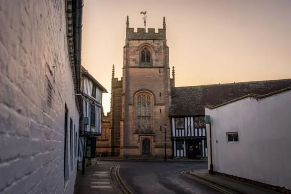 A stone village church tower against the sky, the landmark St Augustine's has been at Locking since 1380