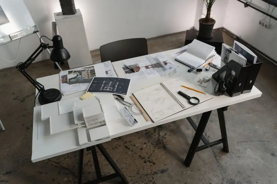 Comparing written flat roofing quotes and specifications on a desk