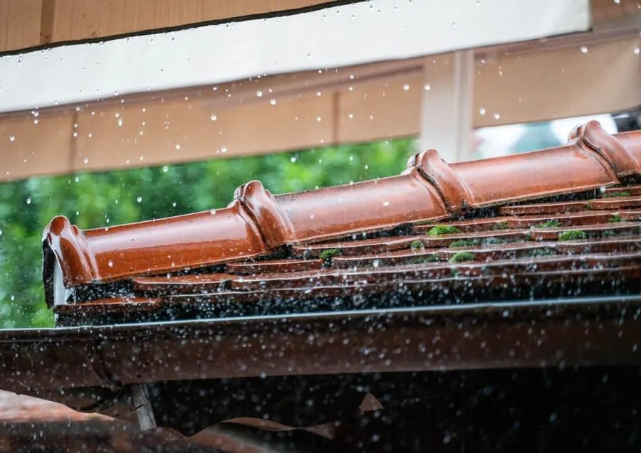 Rainwater pouring over a roof edge instead of into the outlet, an early warning worth investigating