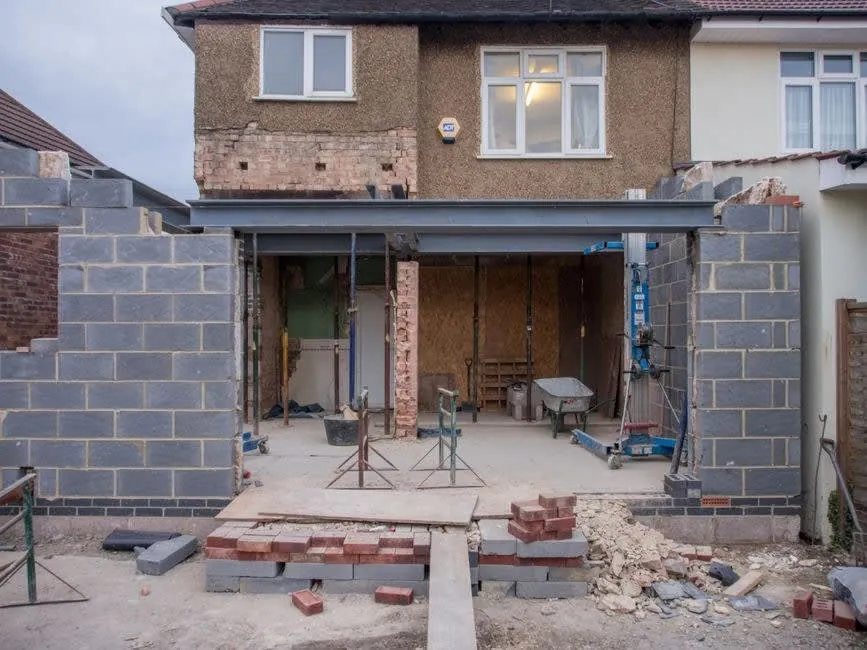 A flat-roofed extension under construction in Weston-super-Mare before a rooflight opening is trimmed