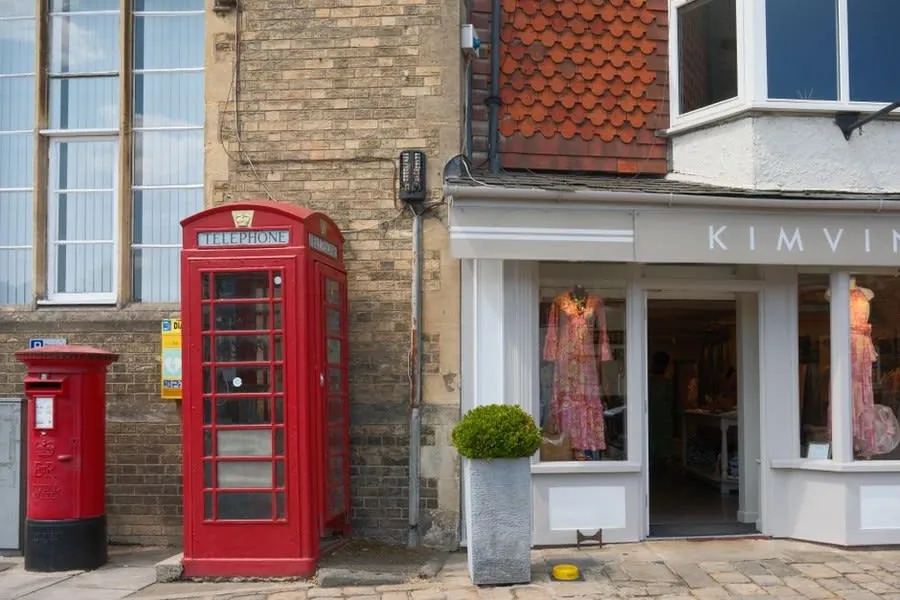 A parade of shops with flat roofs over the shopfronts in a Somerset town centre