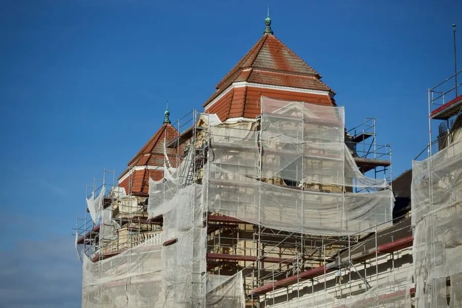 Temporary protective sheeting covering a building during roof works near Weston-super-Mare
