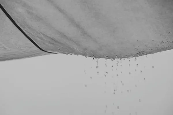 Water dripping through a ceiling caused by a failed flat roof in Weston-super-Mare